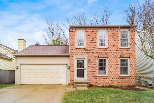 colonial inspired home with roof with shingles, brick siding, an attached garage, a front yard, and driveway