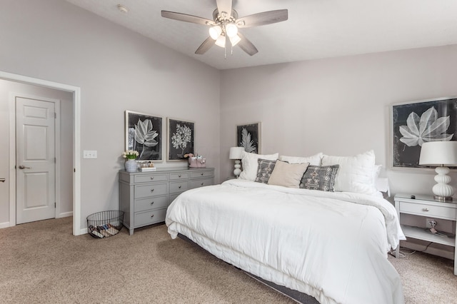 bedroom featuring light carpet, ceiling fan, baseboards, and lofted ceiling