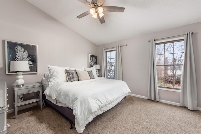 bedroom featuring carpet floors, ceiling fan, baseboards, and vaulted ceiling