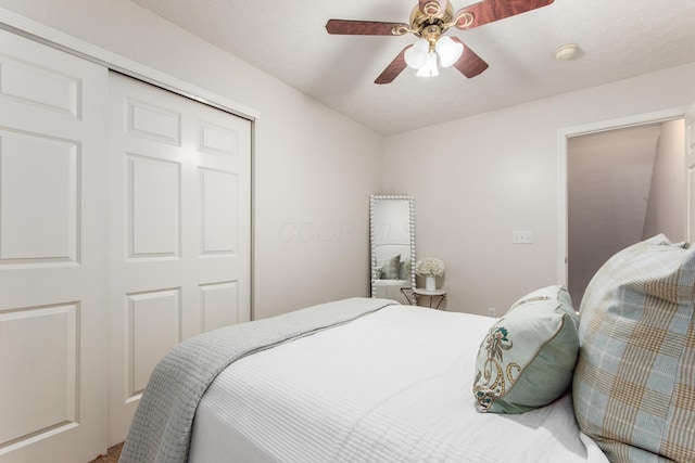 bedroom with ceiling fan and a closet