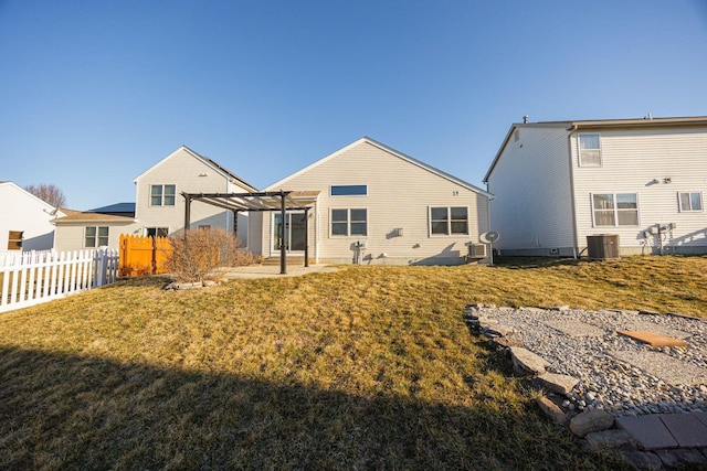 rear view of house with central air condition unit, a lawn, a pergola, fence, and a patio area