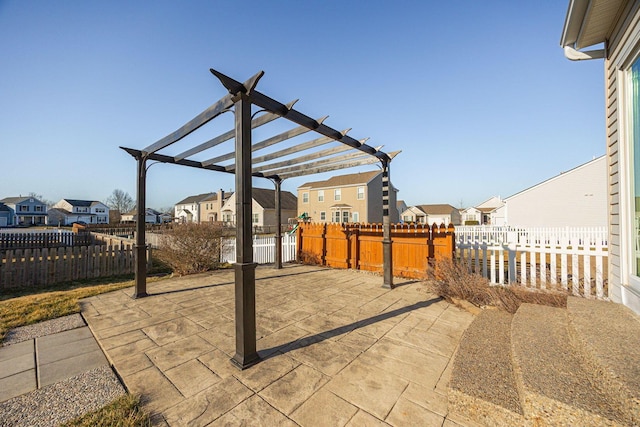 view of patio / terrace with a pergola, fence private yard, and a residential view