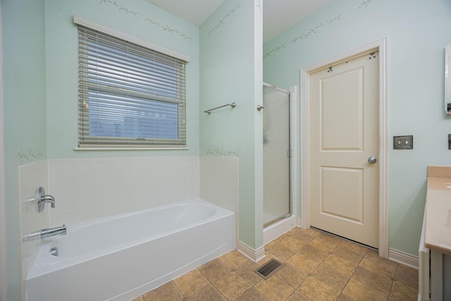 bathroom featuring a bath, visible vents, a shower stall, and vanity