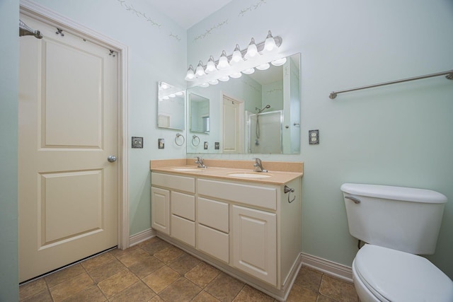 bathroom with double vanity, toilet, a shower, and a sink