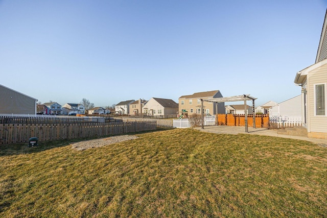 view of yard with a patio area, a residential view, and a fenced backyard