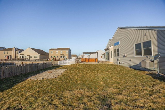 view of yard with a residential view, a patio, and a fenced backyard