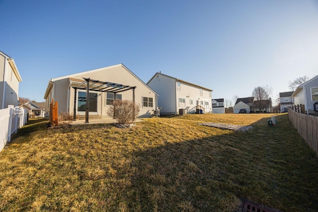 back of house with a patio, fence, a yard, a pergola, and a residential view