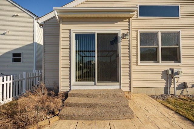 entrance to property featuring fence