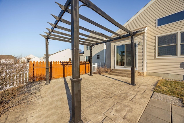 view of patio with fence, entry steps, and a pergola