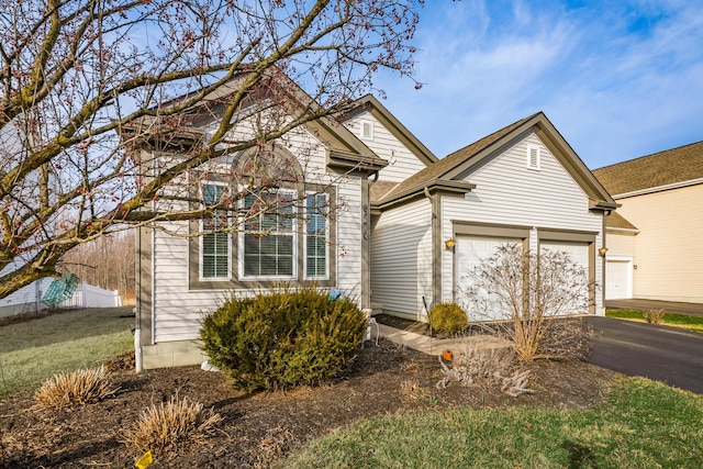 traditional-style house with driveway and an attached garage