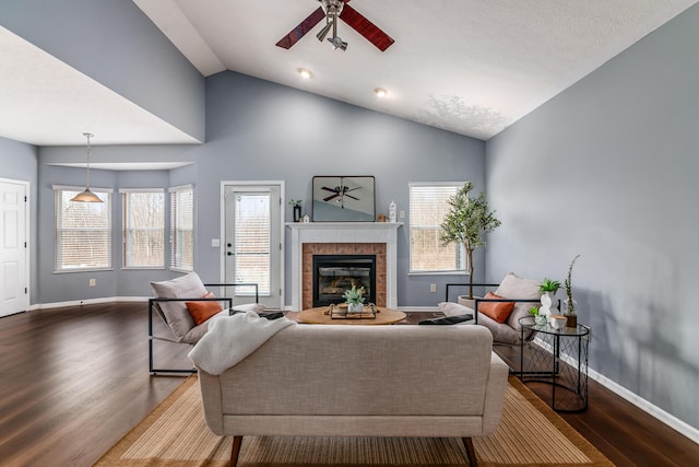 living room featuring ceiling fan, baseboards, and wood finished floors