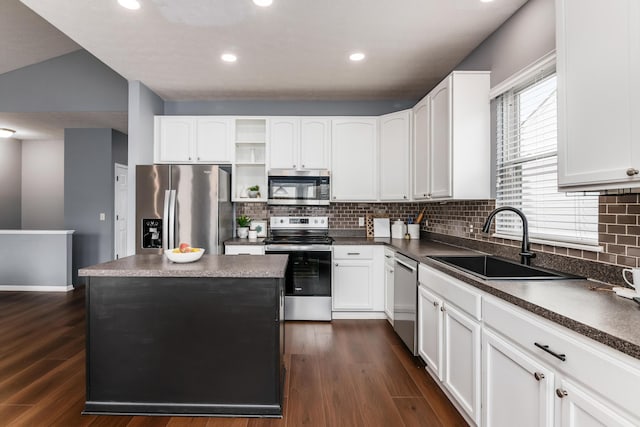 kitchen featuring open shelves, dark wood-style flooring, stainless steel appliances, and a sink