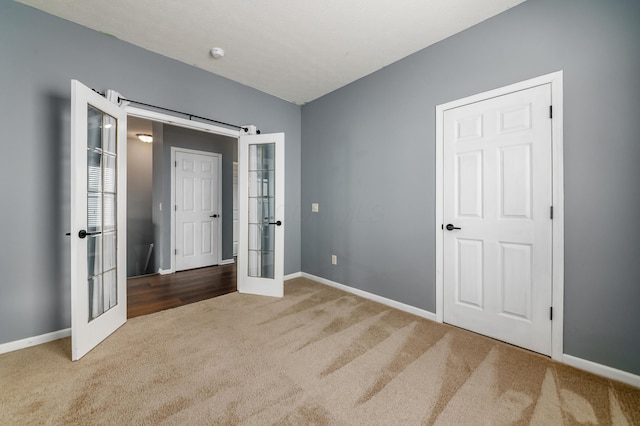 unfurnished bedroom with french doors, carpet, and baseboards