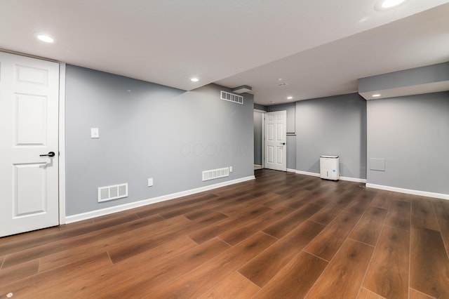 finished basement featuring visible vents and wood finished floors