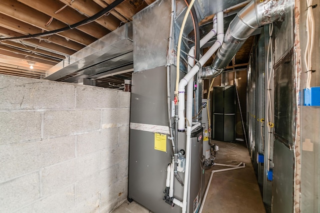 utility room with heating unit and water heater