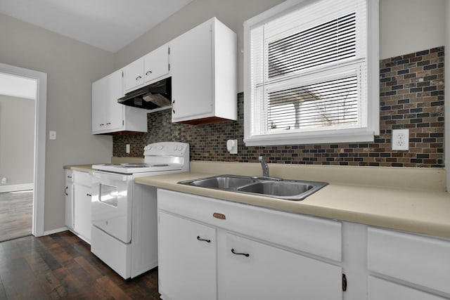 kitchen featuring white electric range oven, backsplash, light countertops, under cabinet range hood, and a sink