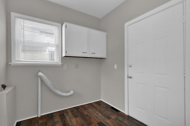 washroom with dark wood finished floors, cabinet space, and baseboards