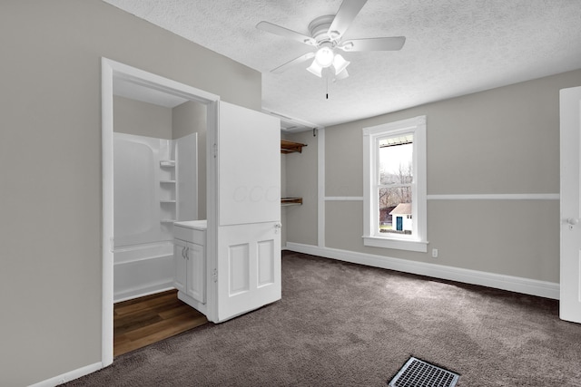 unfurnished bedroom featuring carpet floors, baseboards, visible vents, and a textured ceiling