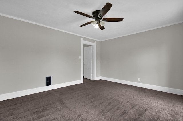 unfurnished room with visible vents, dark carpet, ornamental molding, a ceiling fan, and baseboards