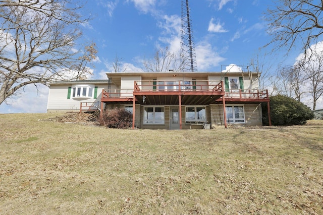 rear view of property featuring a wooden deck and a yard