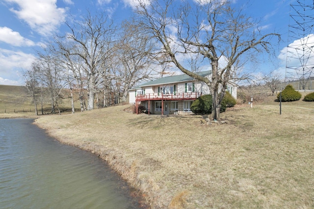 exterior space with a front lawn and a wooden deck