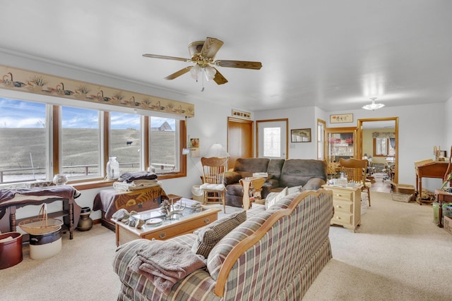 living area with ceiling fan and light colored carpet