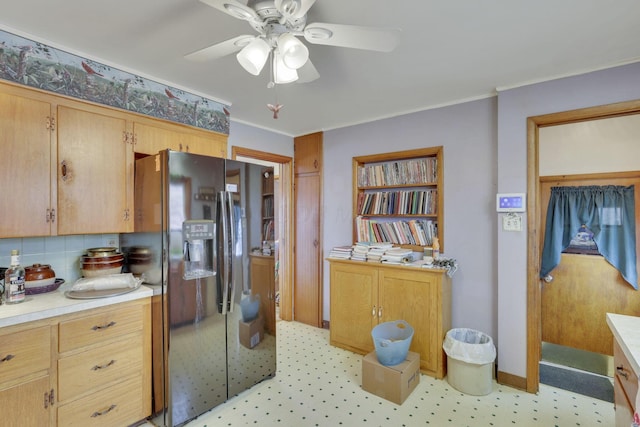 kitchen with ceiling fan, light countertops, ornamental molding, stainless steel refrigerator with ice dispenser, and decorative backsplash