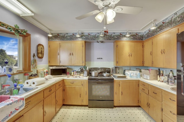 kitchen with light floors, black range with electric cooktop, stainless steel microwave, and light countertops