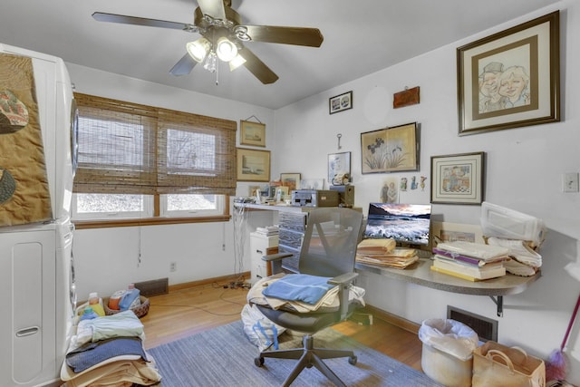 office space with washer / dryer, ceiling fan, baseboards, and wood finished floors