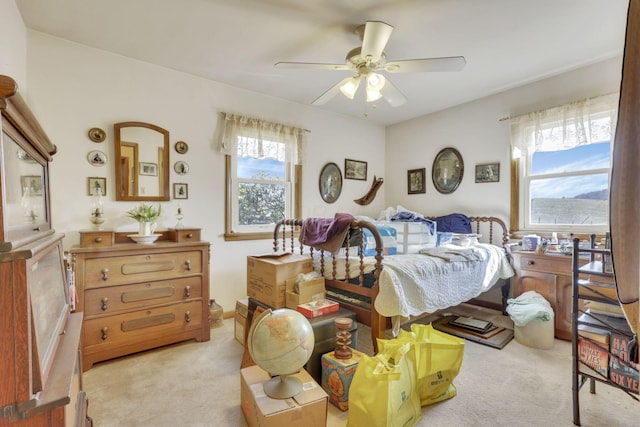 bedroom featuring light carpet and ceiling fan