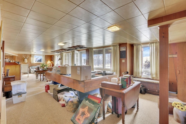 office area featuring carpet floors and wood walls