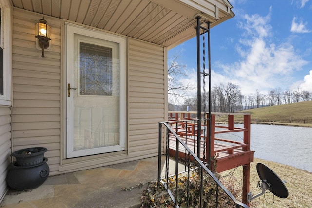 doorway to property with a water view