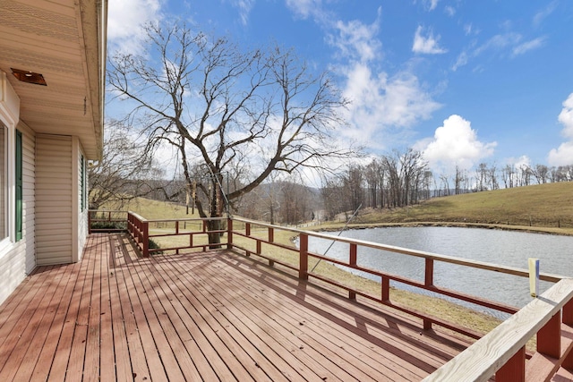 wooden deck featuring a water view and a lawn