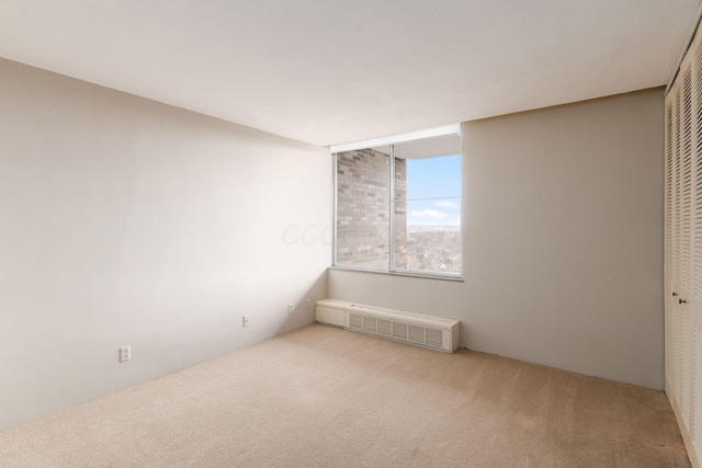 carpeted spare room featuring visible vents