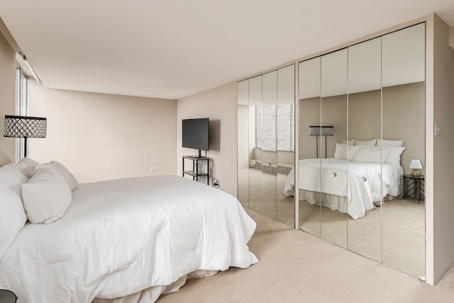 bedroom featuring light carpet