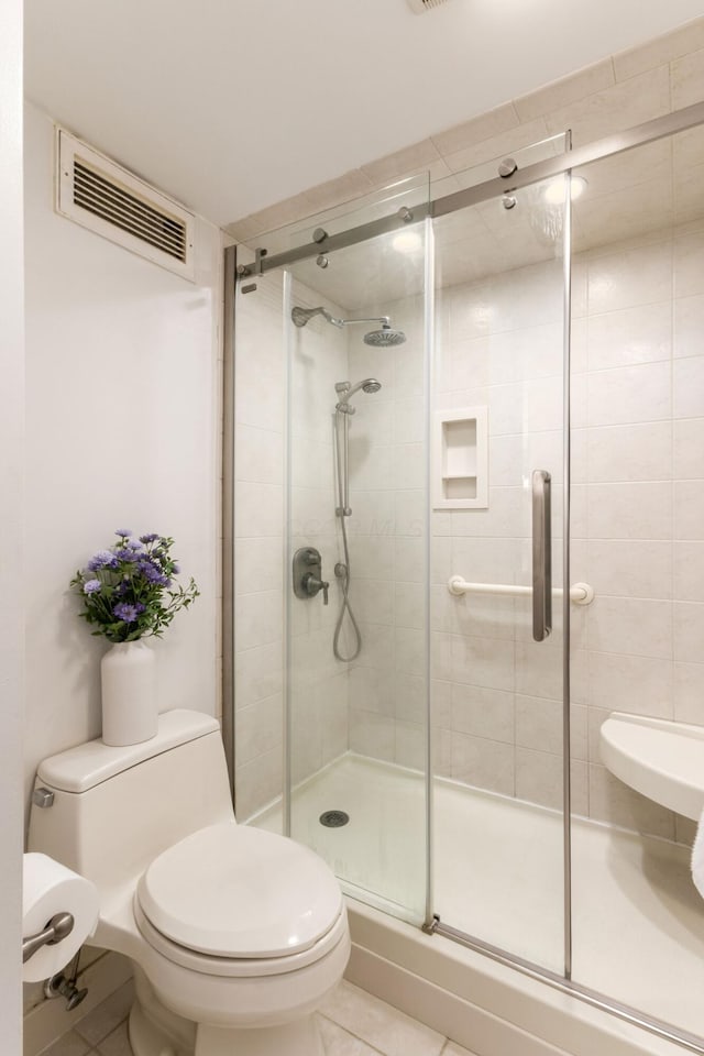 full bathroom with toilet, a shower stall, visible vents, and tile patterned floors