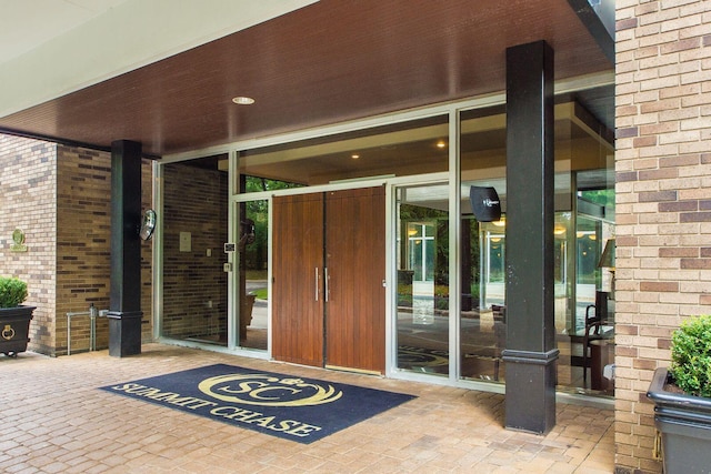 view of exterior entry featuring brick siding