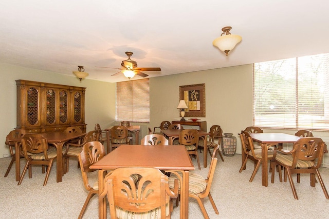 dining room featuring light carpet and ceiling fan