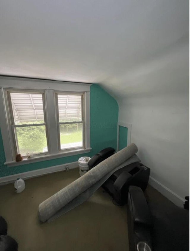 interior space with lofted ceiling and baseboards