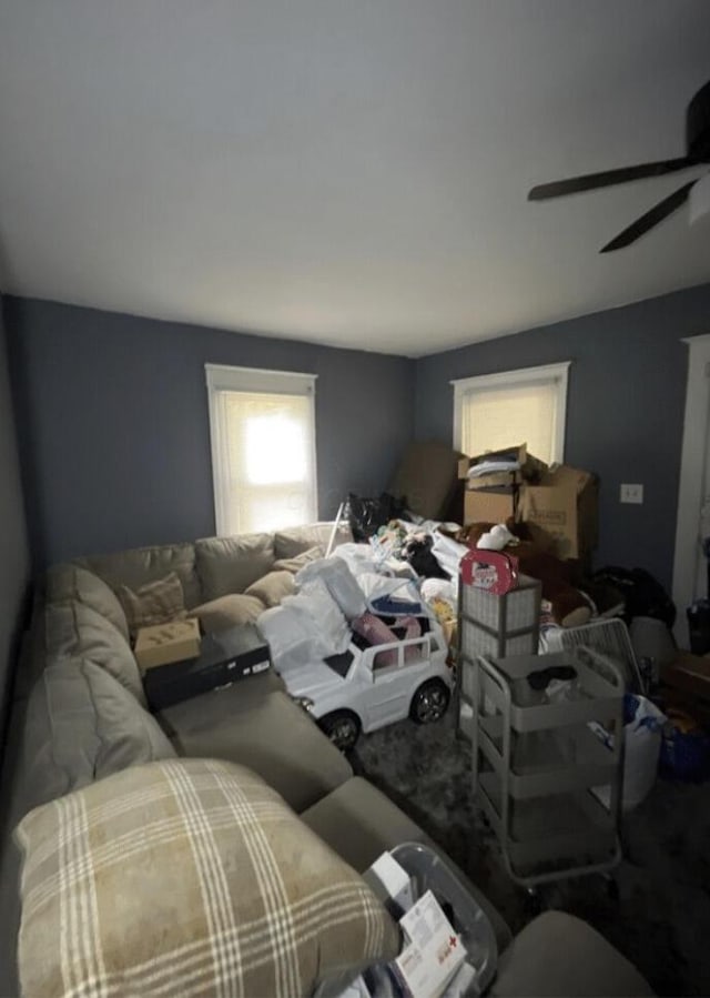 living area featuring a ceiling fan