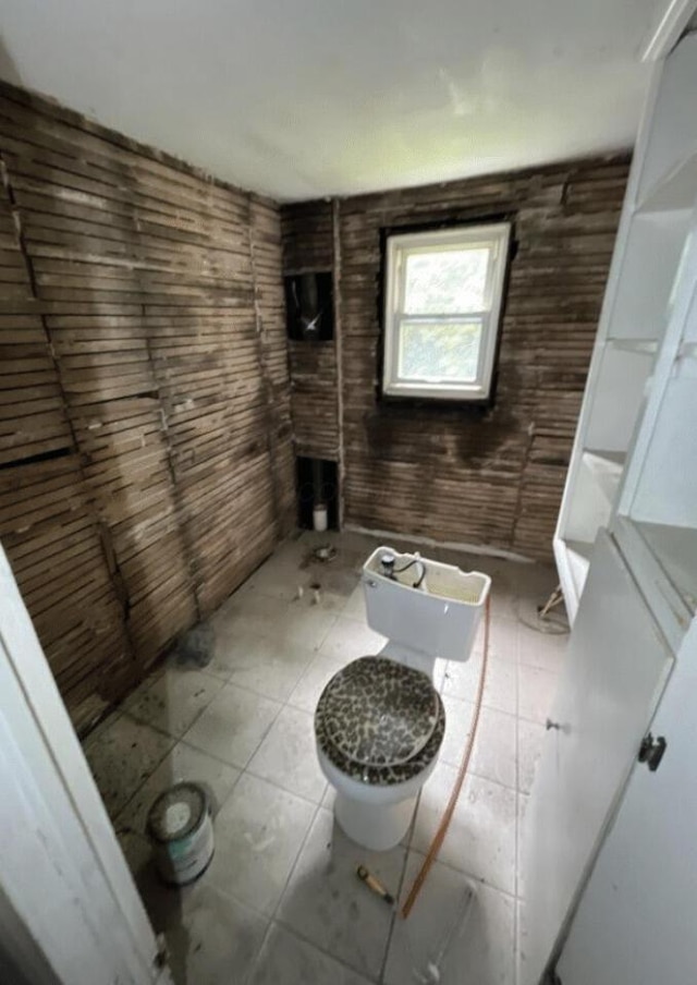 bathroom with toilet and tile patterned flooring