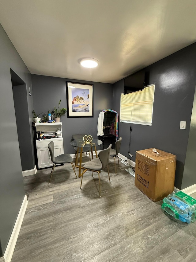 living area featuring baseboards and wood finished floors