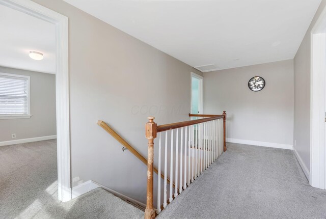 stairs featuring baseboards and carpet flooring