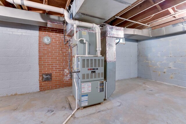 utility room featuring heating unit