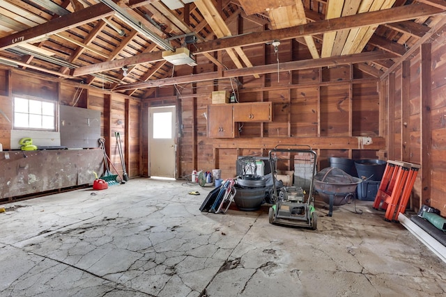 misc room featuring a garage and lofted ceiling