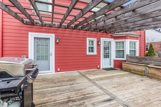 deck with grilling area and a pergola