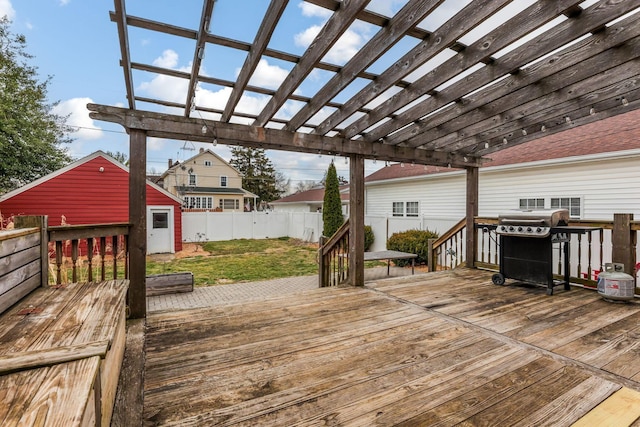 wooden terrace with area for grilling, fence, an outdoor structure, a lawn, and a pergola