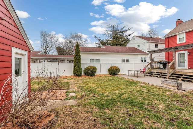 view of yard with a fenced backyard, a deck, and a patio