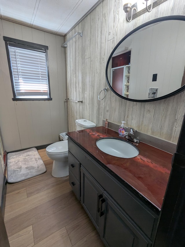 full bath featuring toilet, walk in shower, and vanity