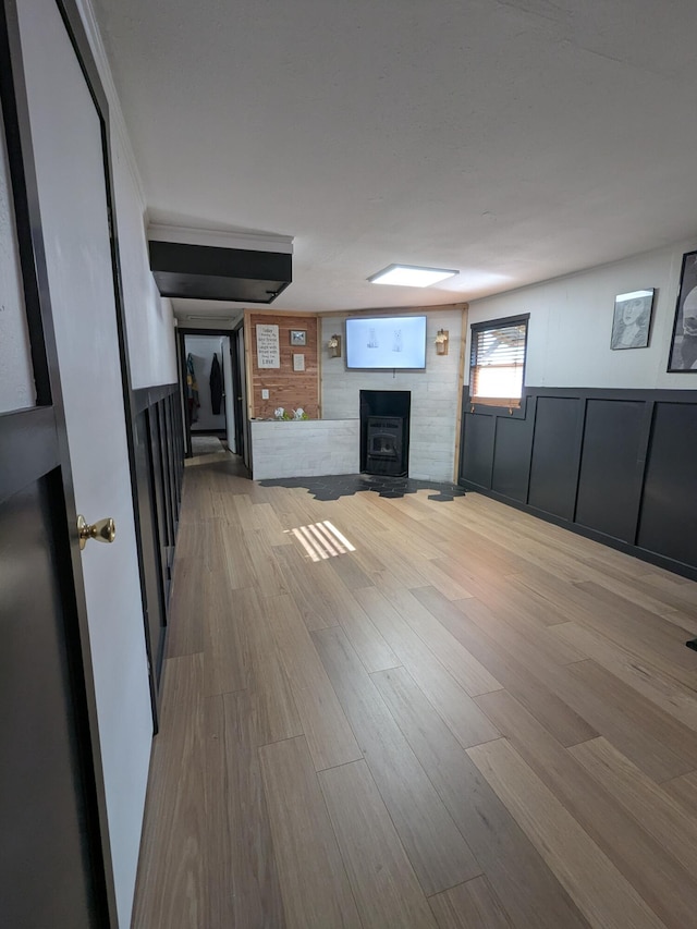 unfurnished living room with a decorative wall and wood finished floors